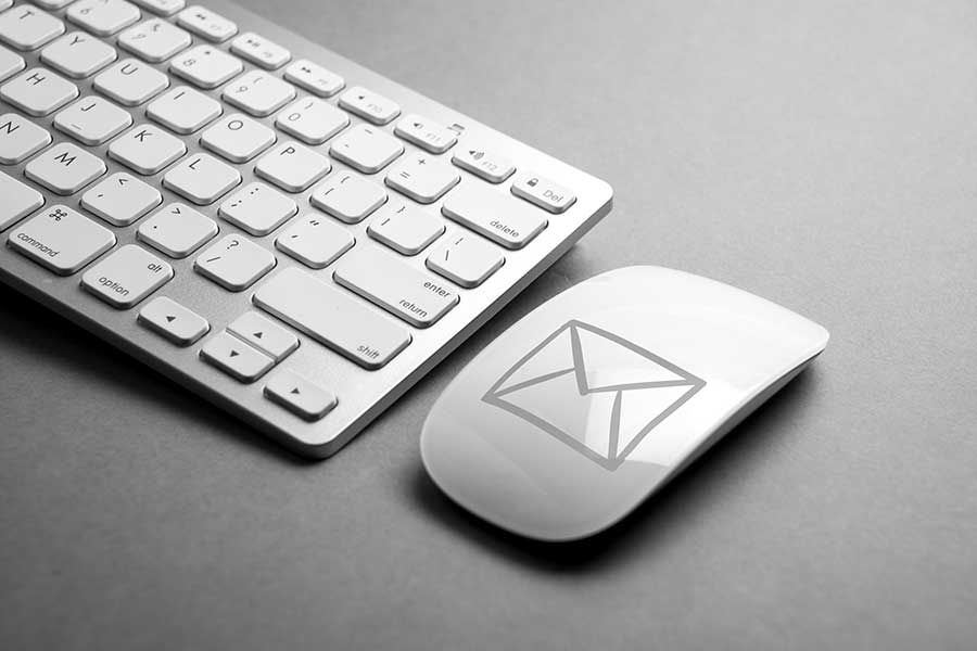 Computer keyboard and mouse with email icon, digital communication and email marketing concept