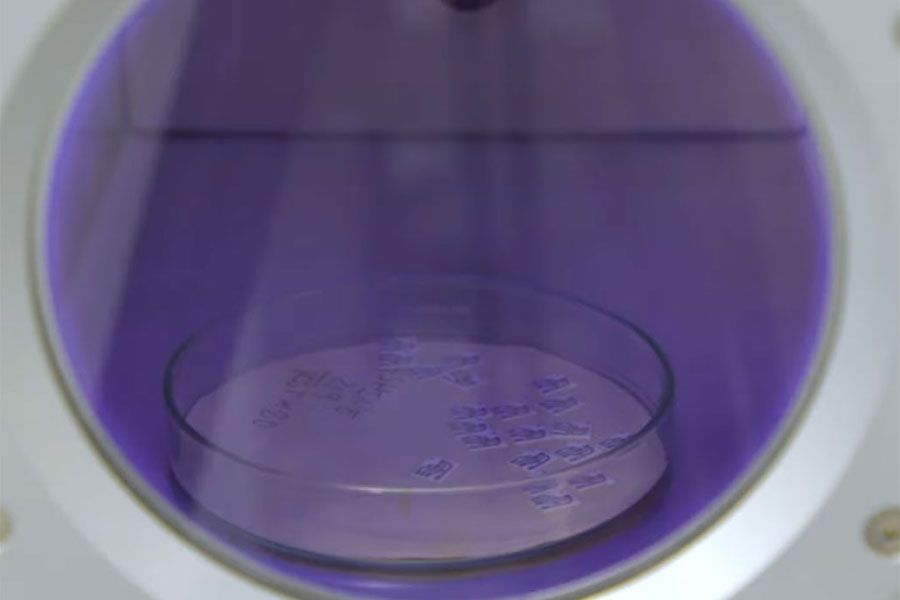 Small components inside vacuum plasma chamber undergoing surface treatment for improved adhesion and cleaning performance